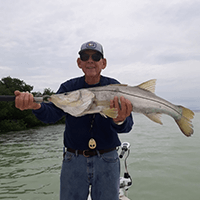 captain bill holding a fish