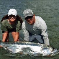 captain mark and a woman holding a fish