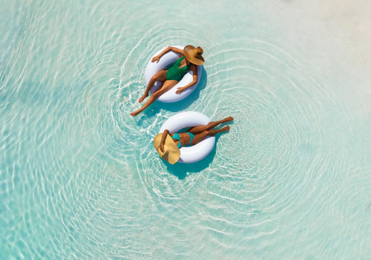 Two women floating in inner tubes in the pool at La Siesta Resort in the Florida Keys.