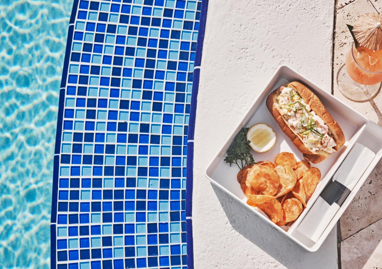 A plate of food sitting by the pool.