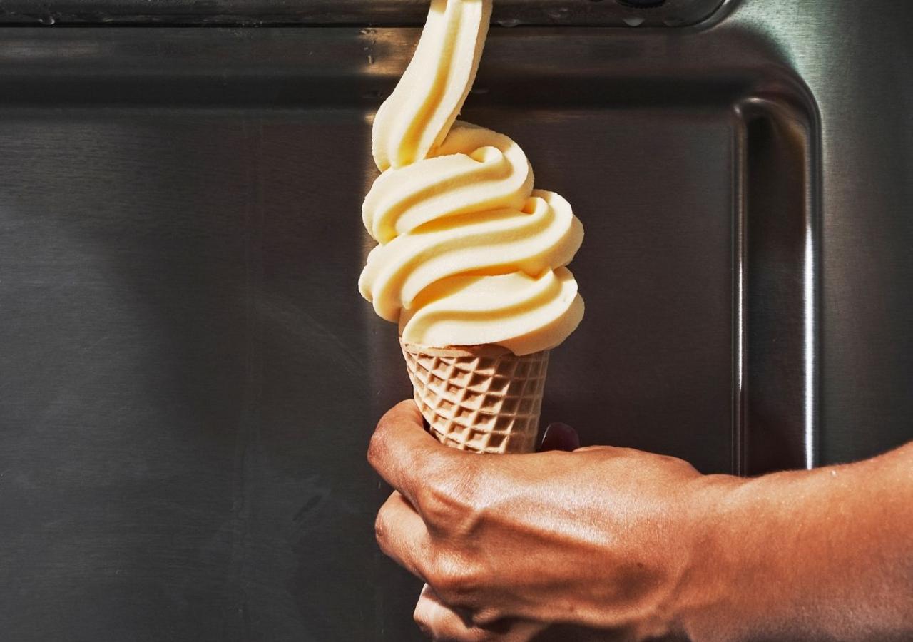 Soft serve ice cream dispensing into a cone