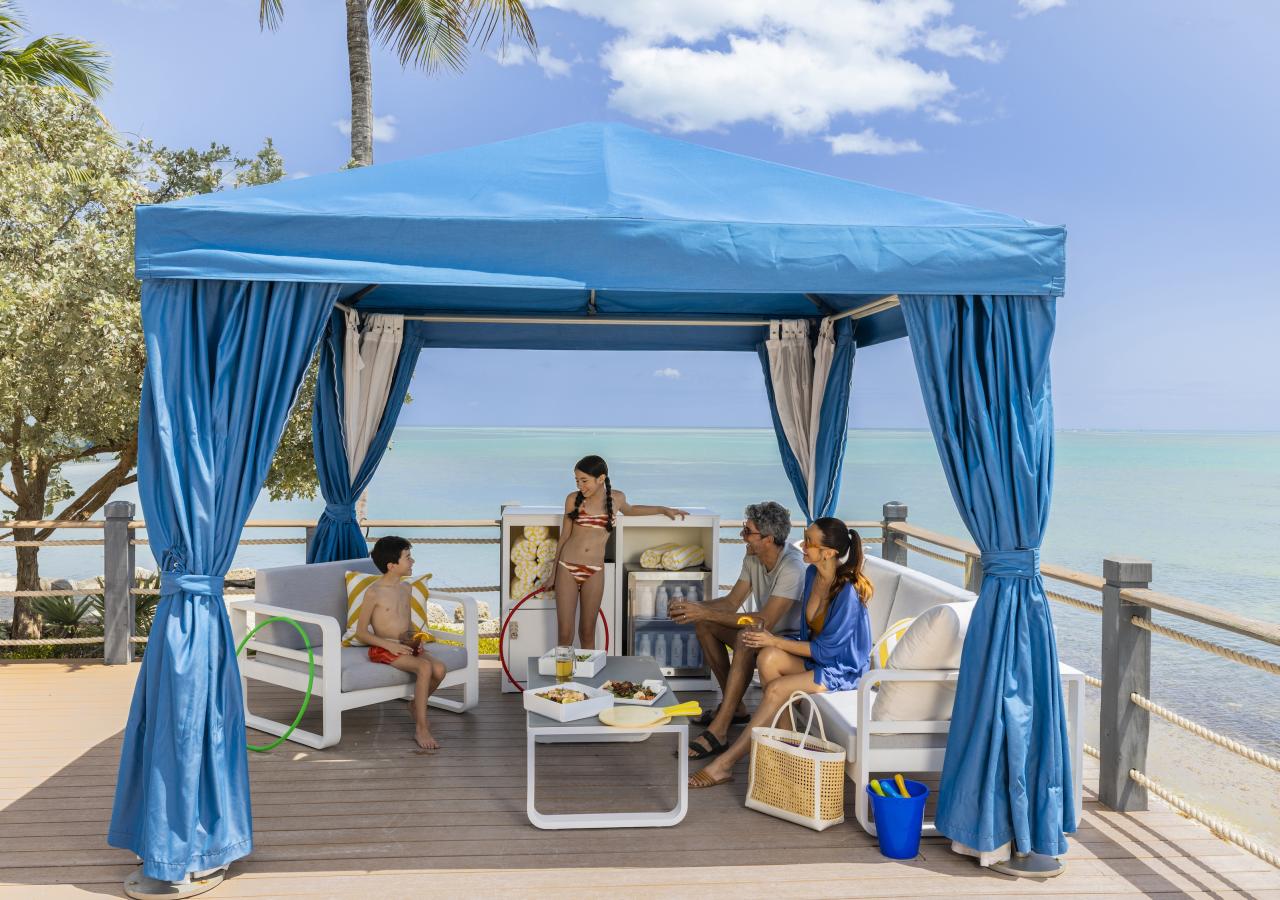 Family enjoying a cabana by the ocean