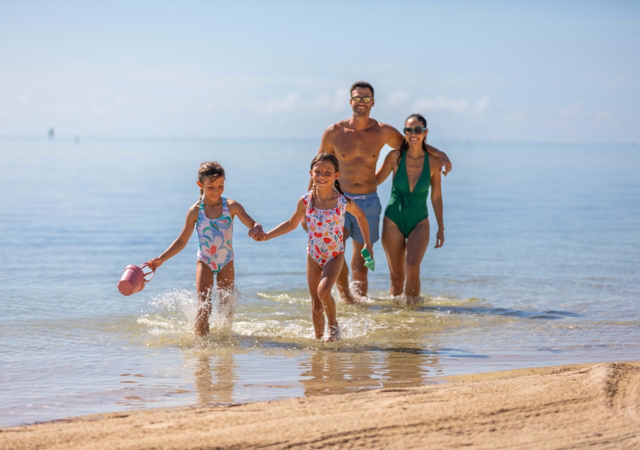 A family walking on the beach in the Keys.