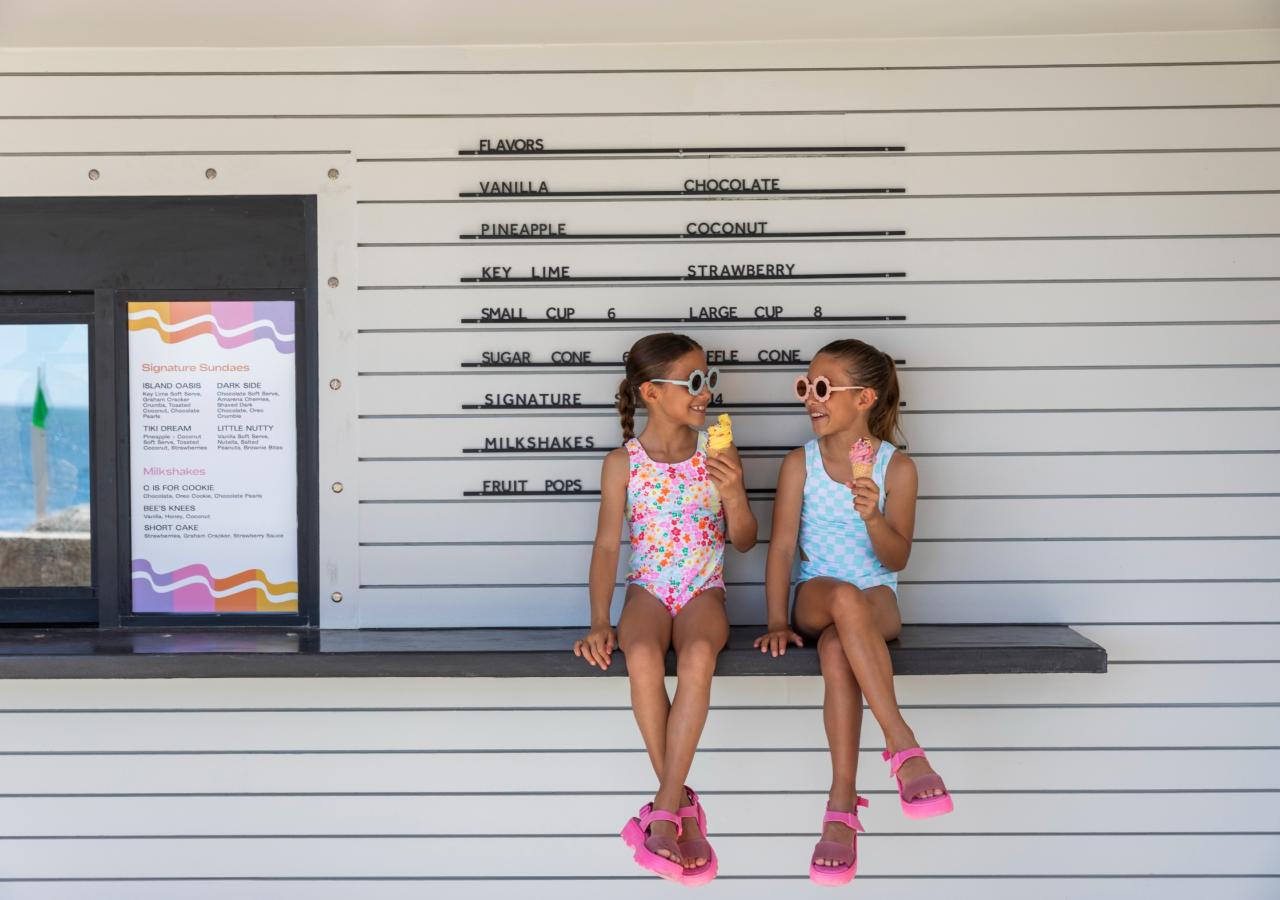 Two little girls enjoying ice cream from Lucky Twist at Three Waters Resort & Marina.