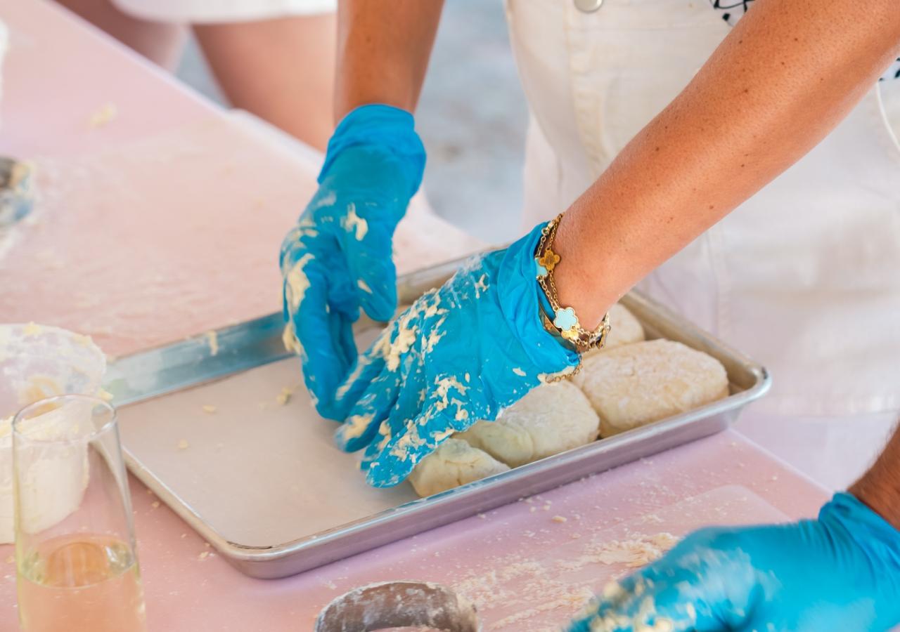Guests making biscuits at the Biscuits and Bubbles class at Three Waters Resort & Marina for Helm to Hearth.