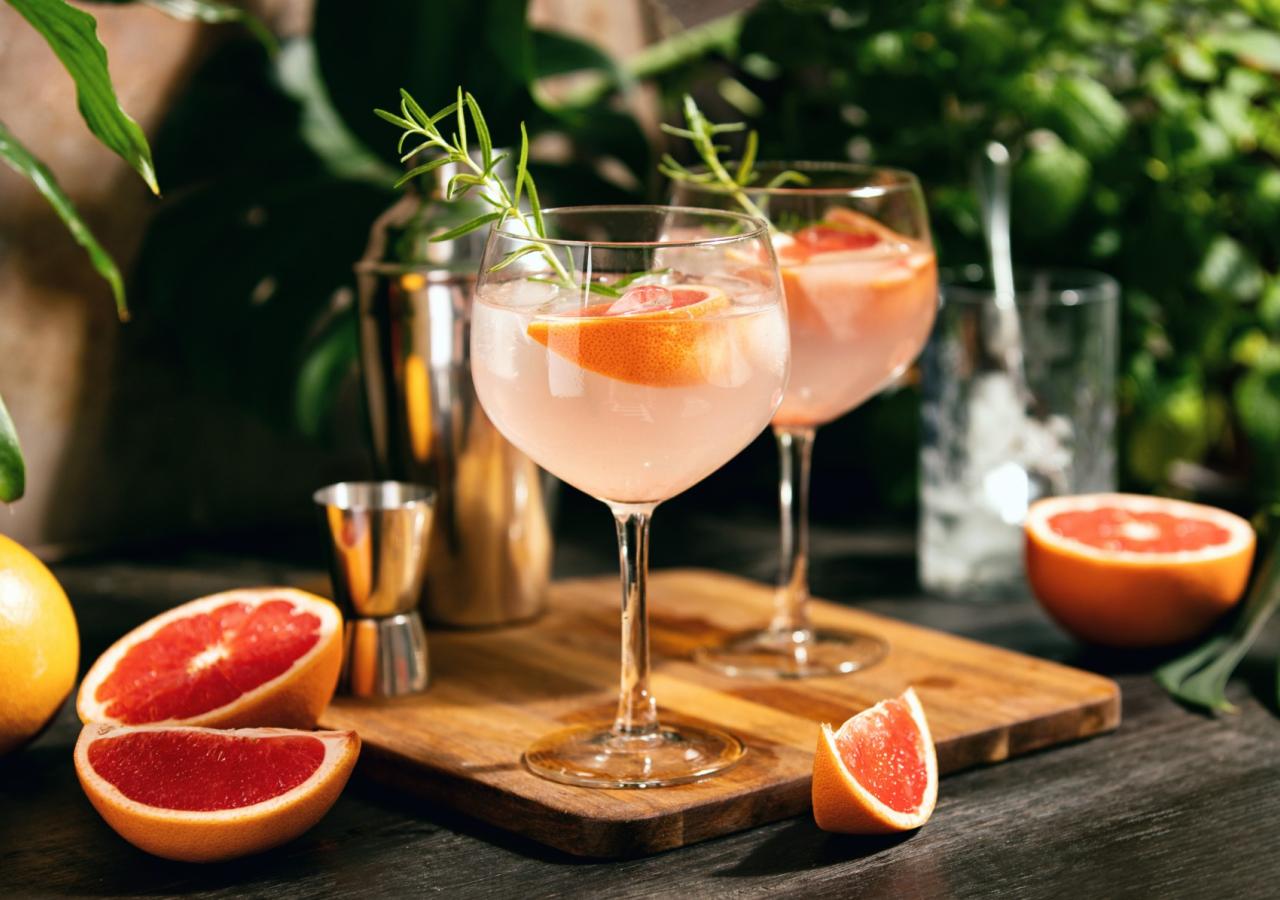Grapefruit cocktails on a wooden serving board 