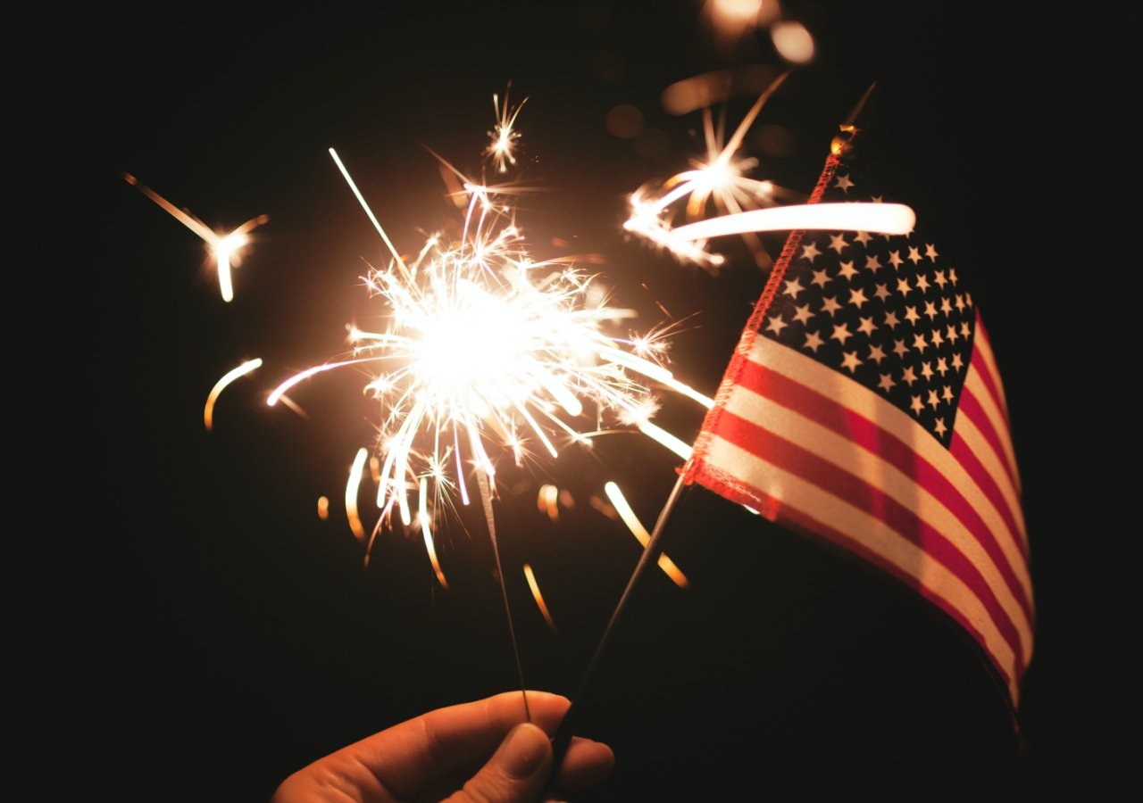 american flag with fireworks in the background