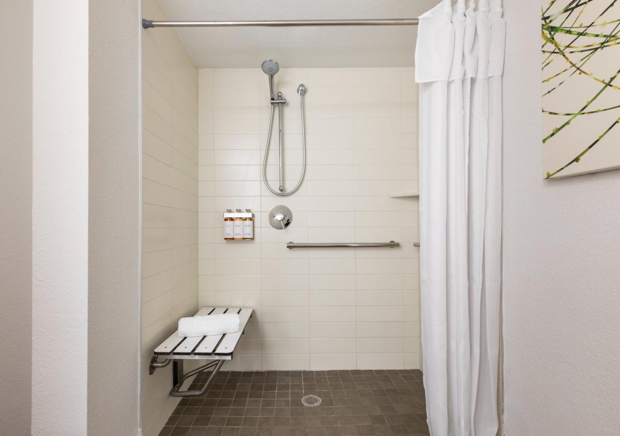An accessible shower with a bench.