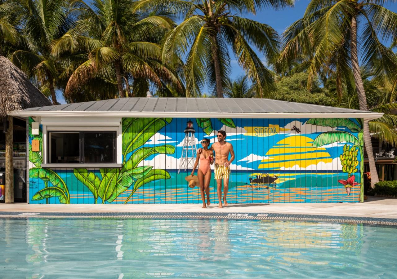 A couple standing in front of Sidecar at La Siesta Resort in the Florida Keys.