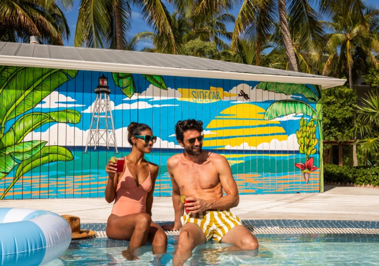 A couple sitting by the pool at La Siesta, an oceanfront resort in the Florida Keys.