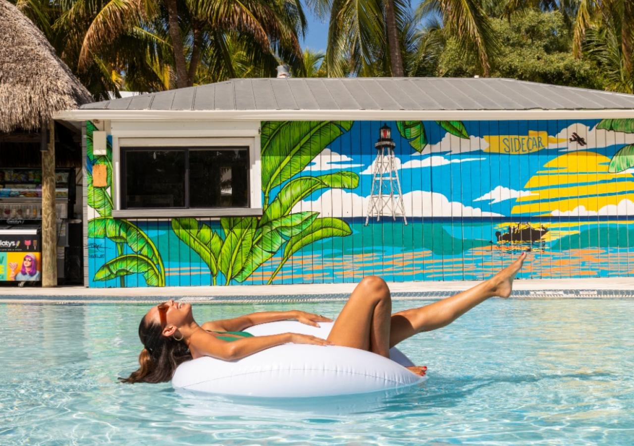 A girl lounging in the pool on an inner tube at La Siesta Resort & Villas in Islamorada, Florida.