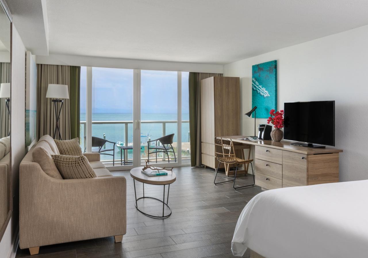 A spacious, ocean facing hotel room filled with lots of natural light