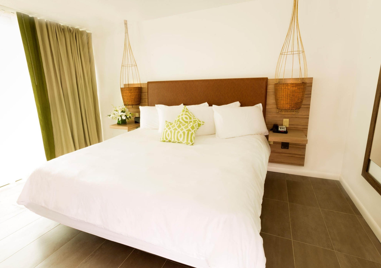 bedroom with king bed and lime green decorations