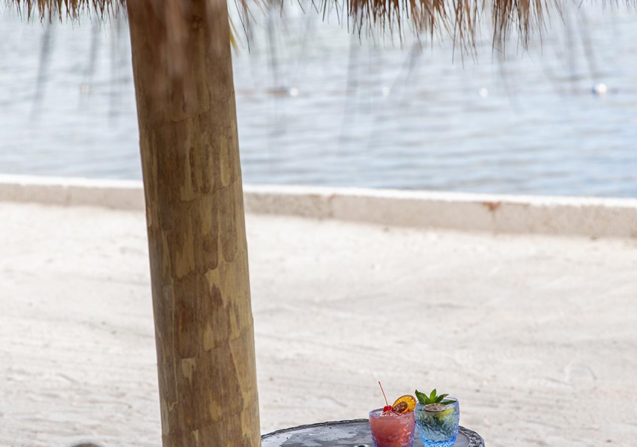 Drinks set up on a table under a tiki at Amara Cay Resort in Islamorada, Florida.