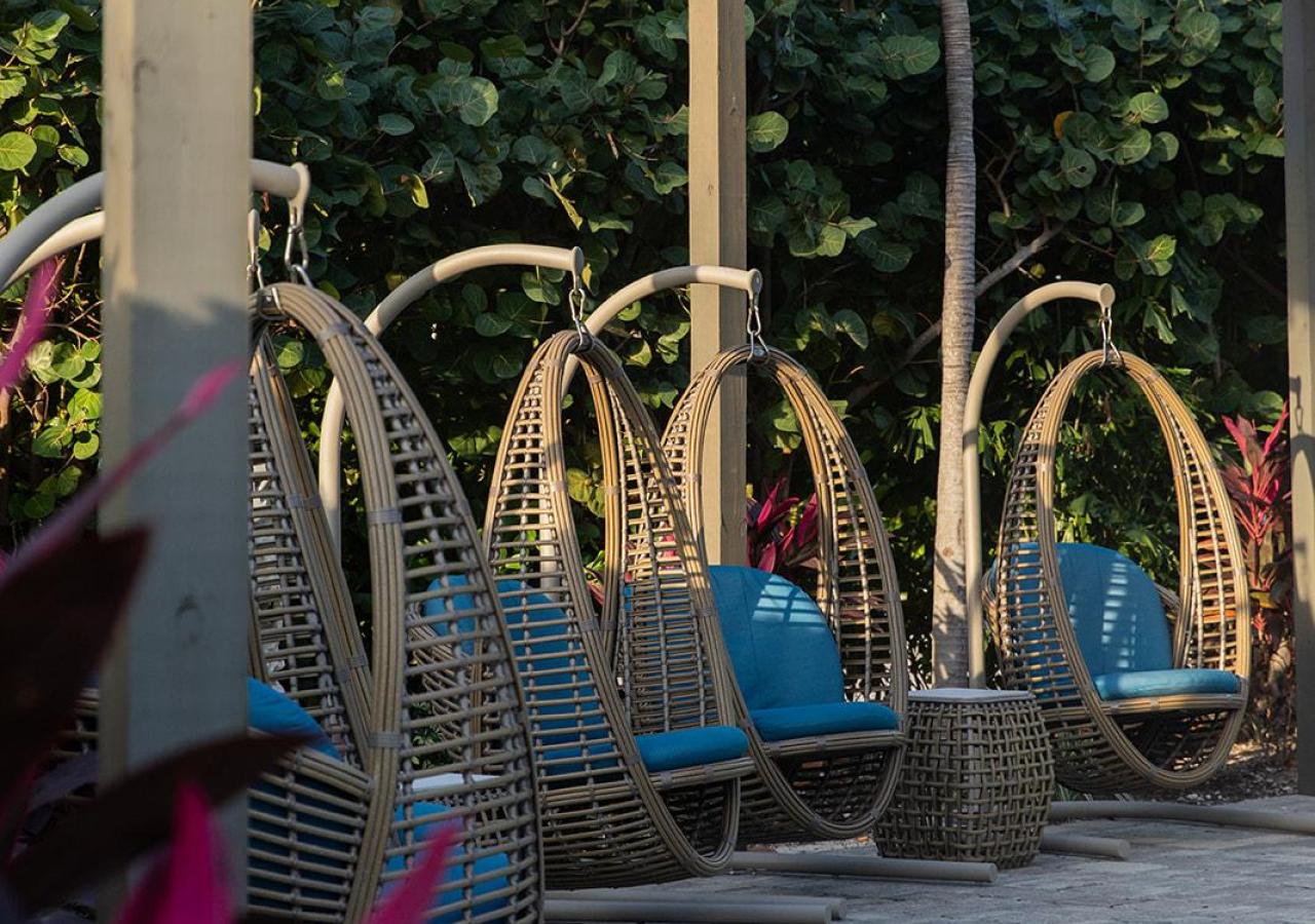 Swing chairs outside the lobby at Three Waters Resort & Marina in Islamorada, Florida.