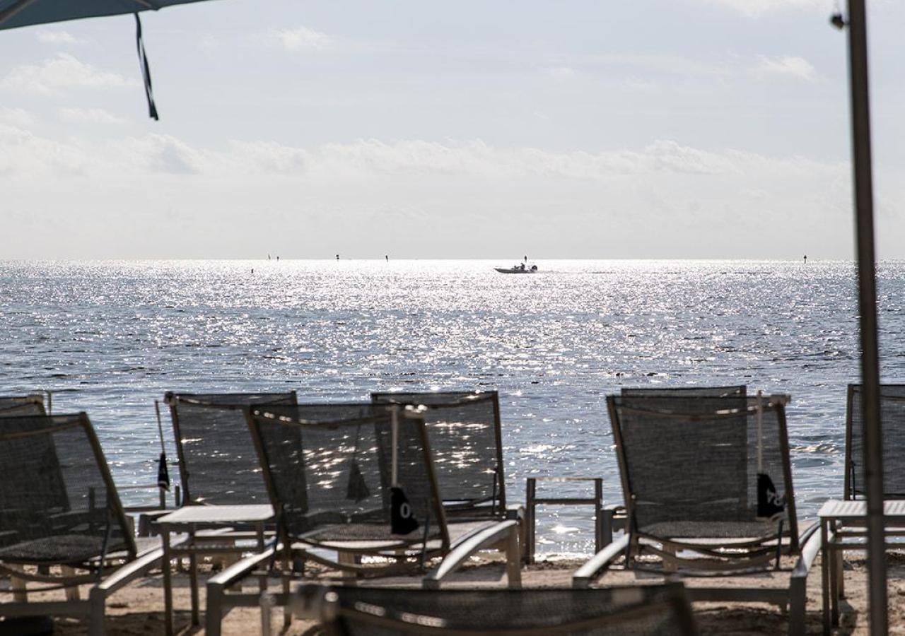 Chaise lounges set up at the beach at Three Waters Resort & Marina.