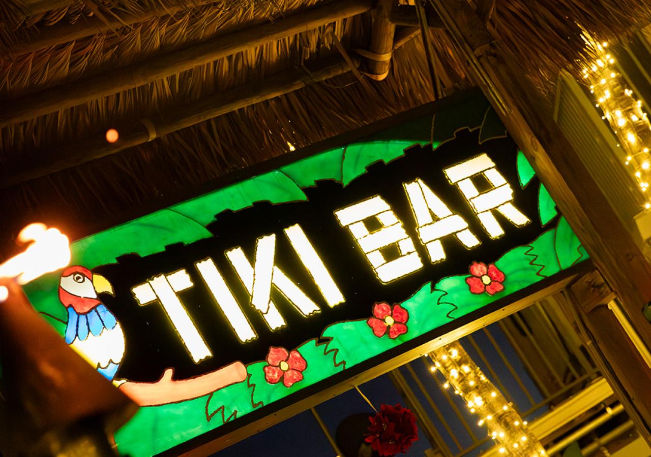 The iconic World-Famous Tiki Bar sign where the rum runner was invented at Three Waters Resort & Marina.