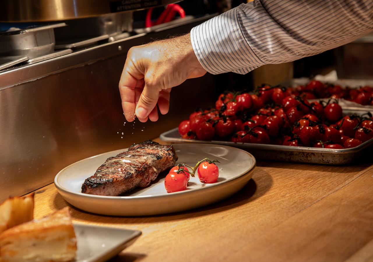 Kindler steak dinner being prepped at the steakhouse in Islamorada, Kindler at Three Waters Resort & Marina.