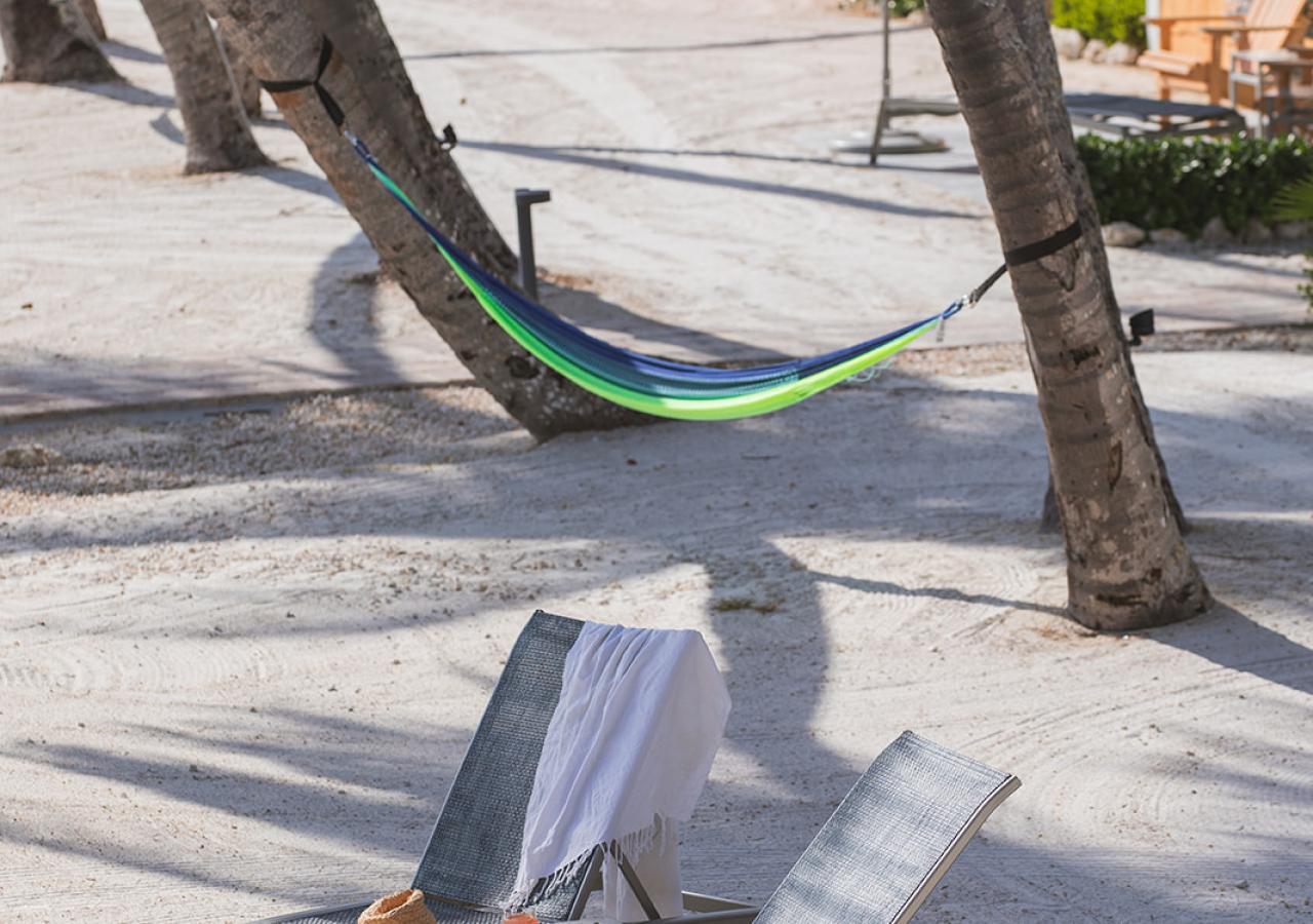 Two lounge chairs in front of the beachfront cottages at La Siesta in the Florida Keys.
