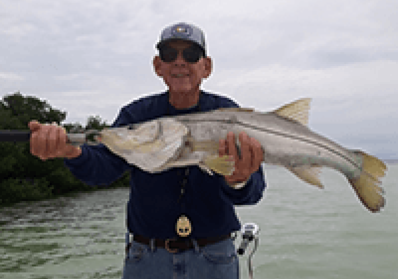 captain bill holding a fish
