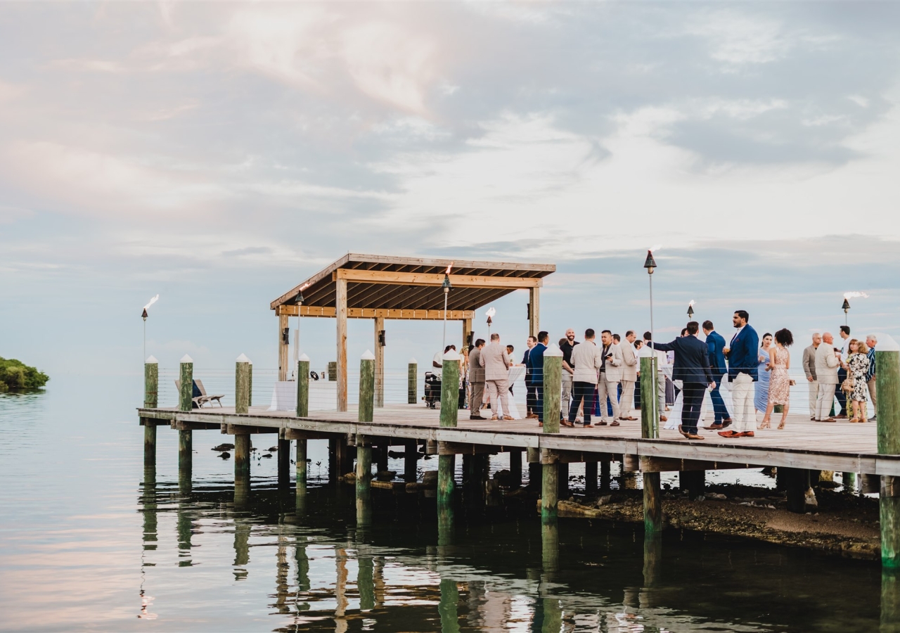 Individual on a pier over the ocean, having an event. 