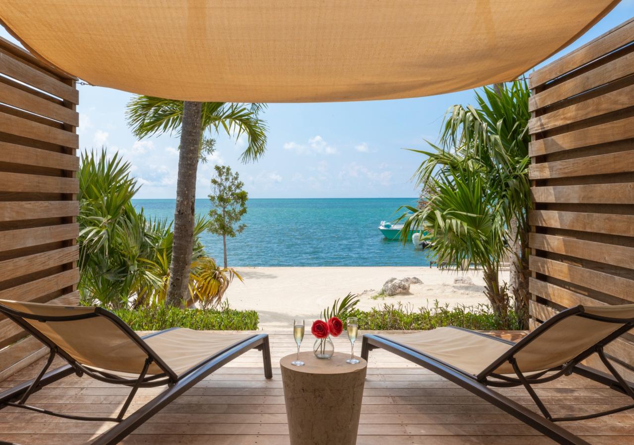 A lanai at La Siesta Resort & Villas. On the Lanai are two chairs with a table between them. 