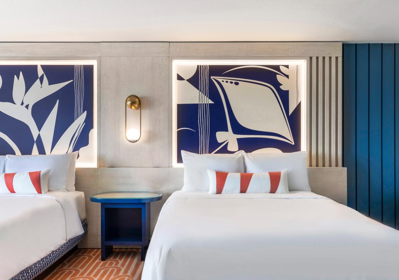 The bed in The Village, 2 BDR Holiday Isle Suite, 1 King and 2 Queens​ at Three Waters Resort & Marina in Islamorada, Florida.