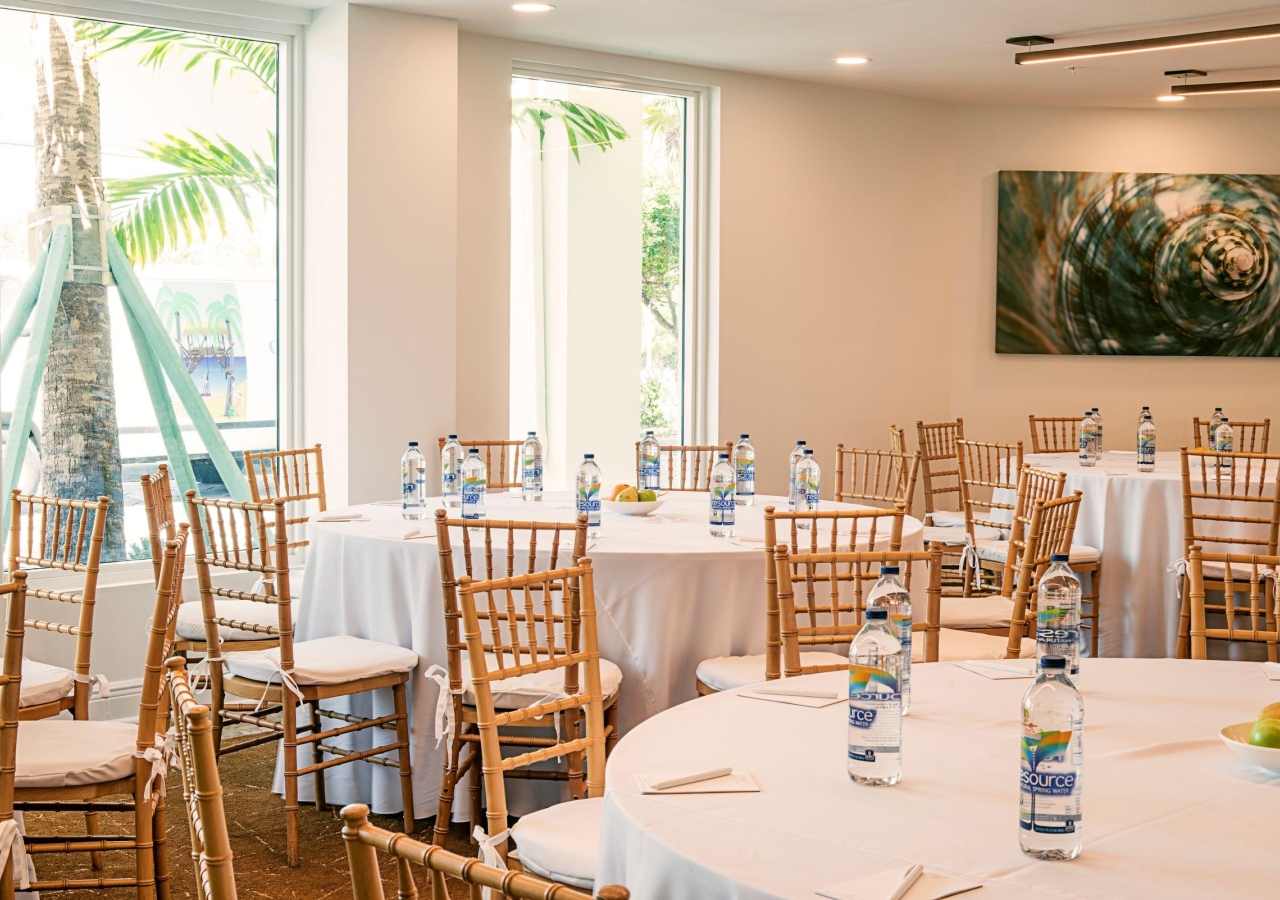 Woman with floor ceiling windows set up for a meeting