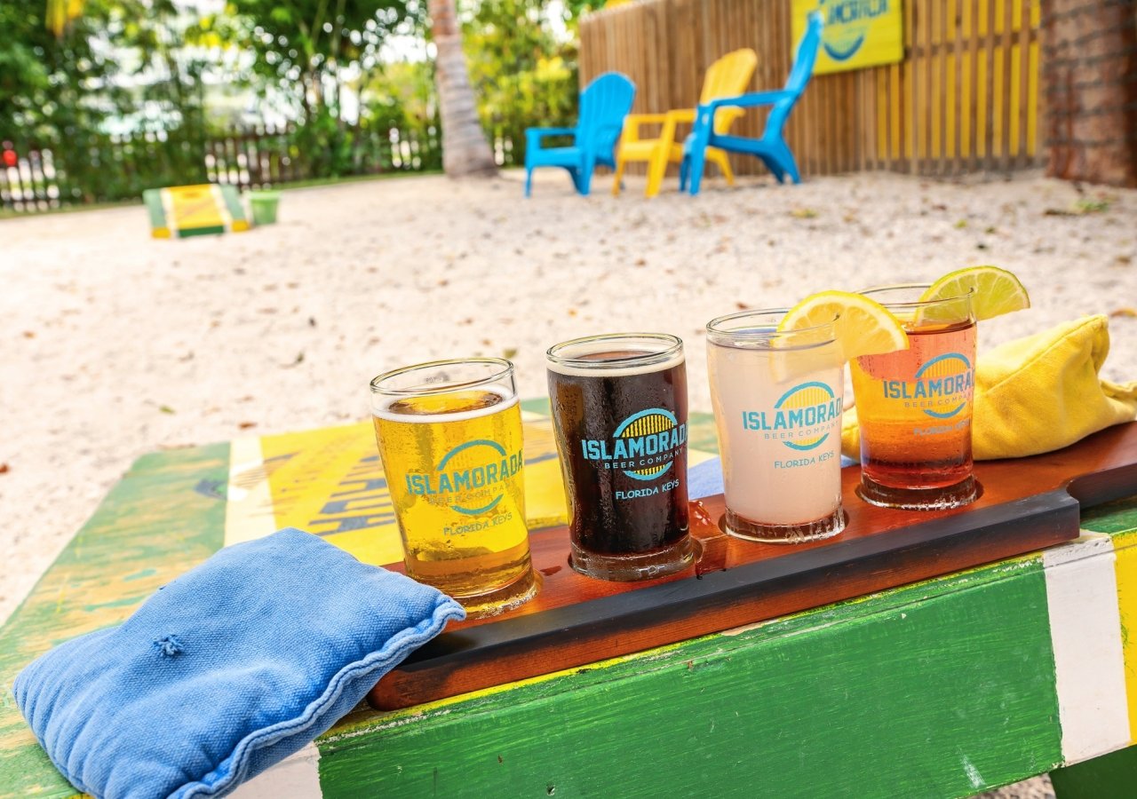 a flight of beer on a corn hole game 