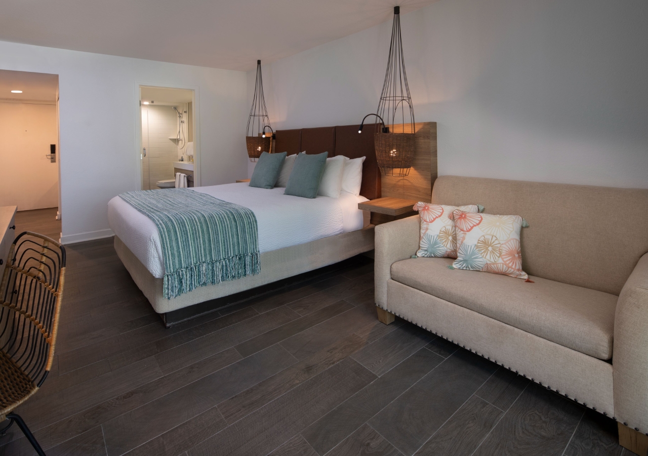 bedroom area in the Oceanfront Two-Bedroom Suite Two King Beds with a sleeper sofa