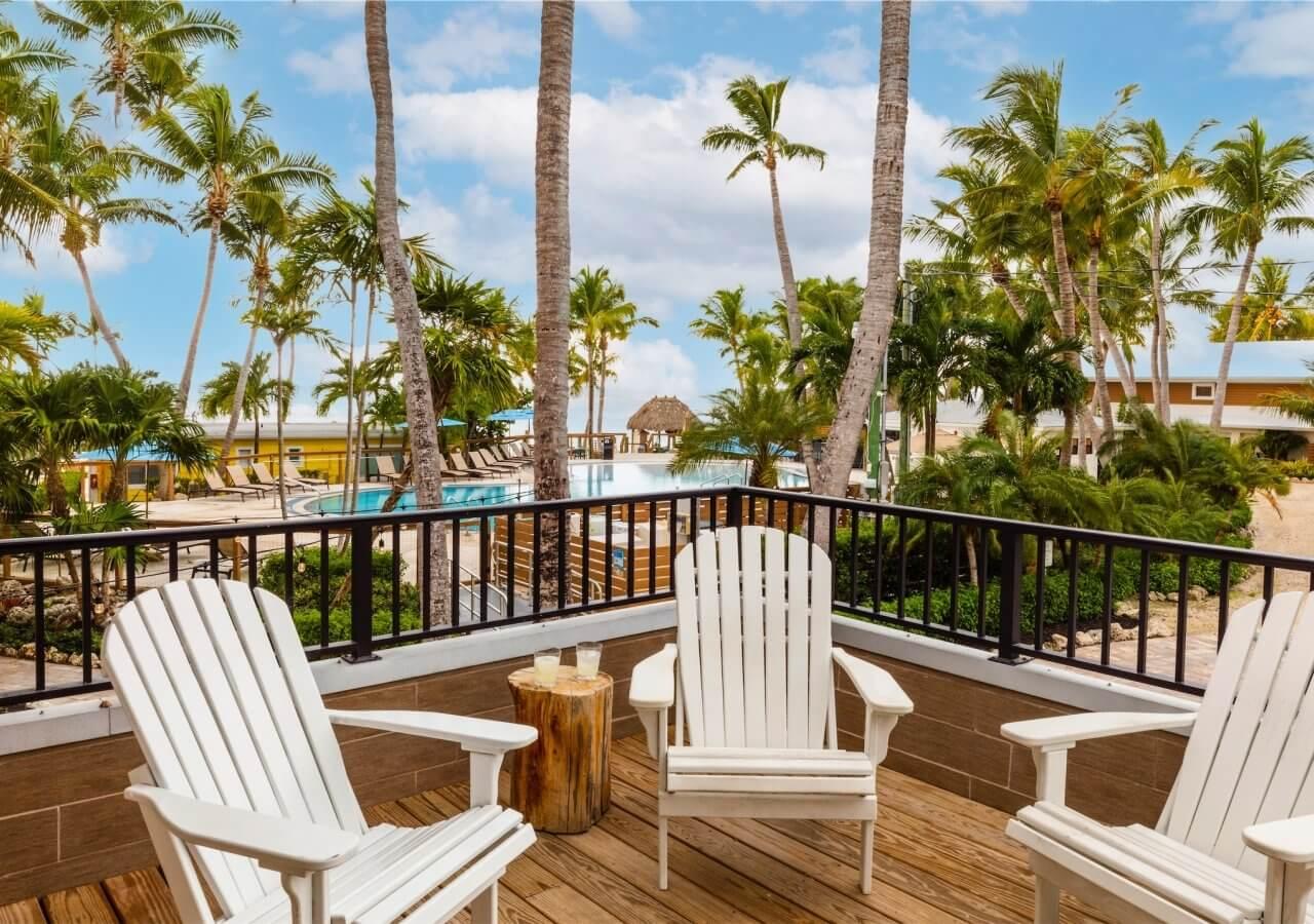 balcony with three adorondak chairs overlooking the resort