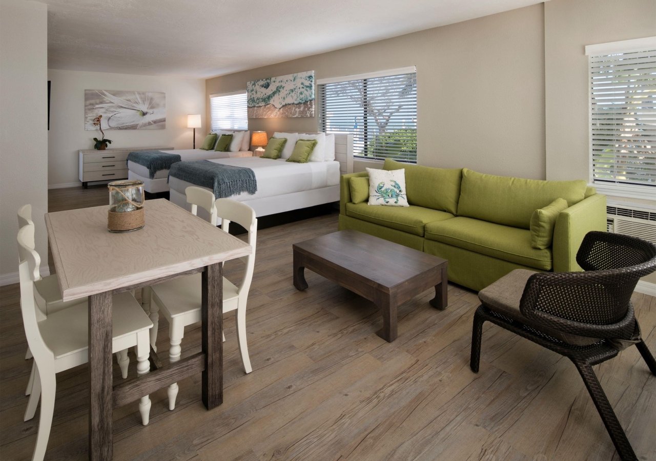 bedroom with two queen beds and a dining and seating area