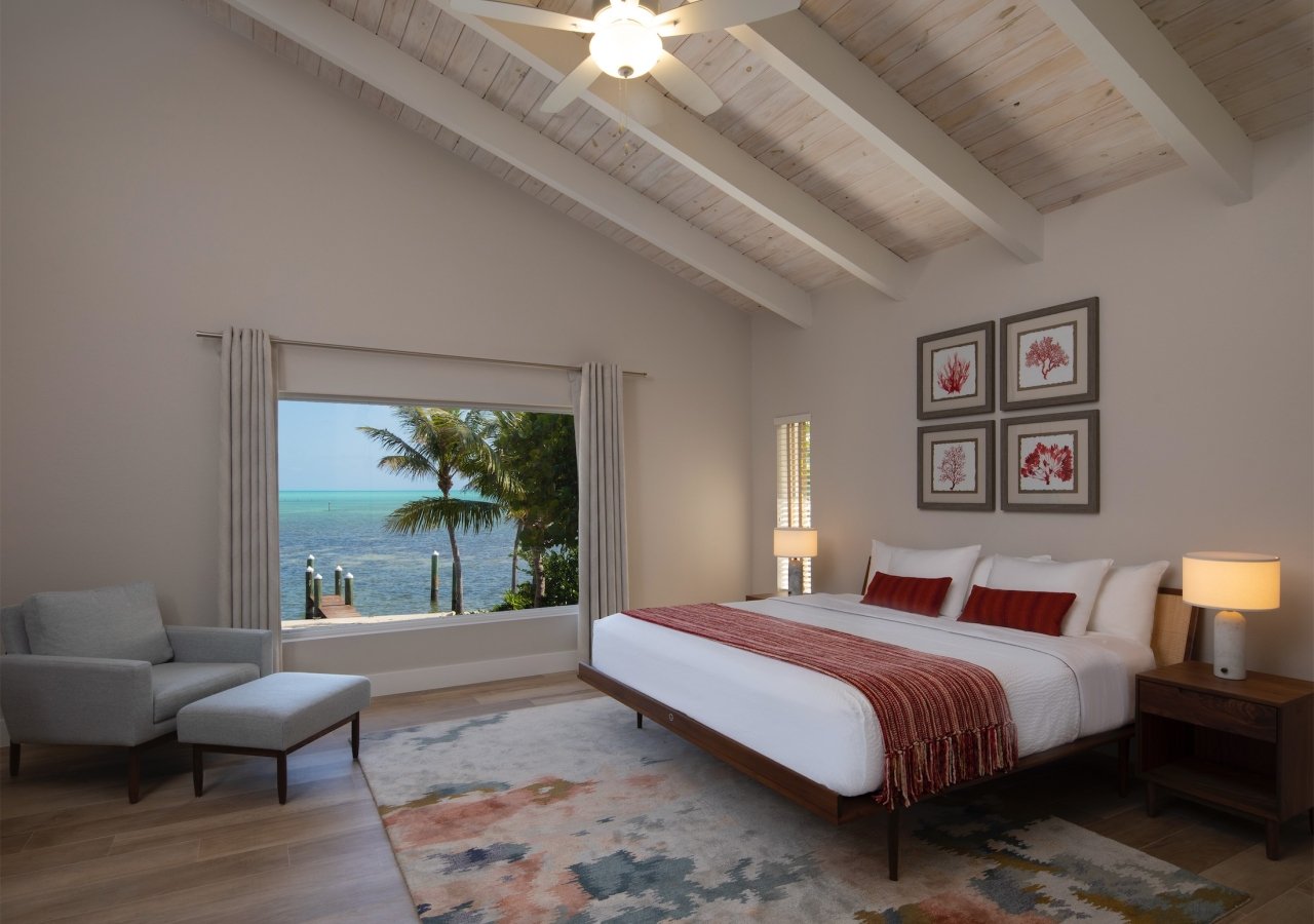 large bedroom with picture window overlooking the beach