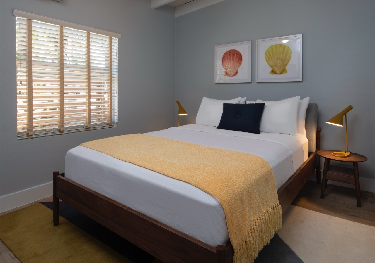 living room with blue walls and king bed