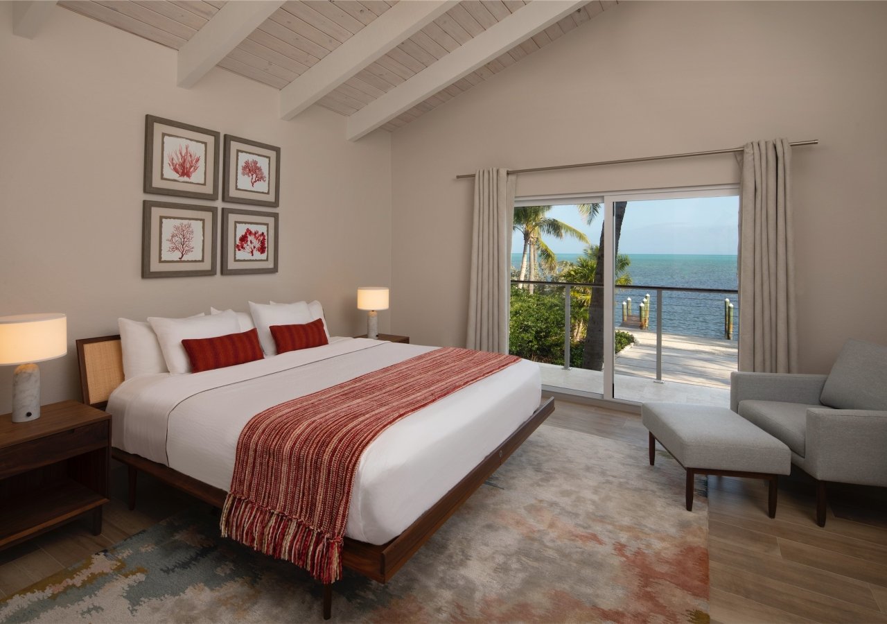 bedroom with patio door and view of beach