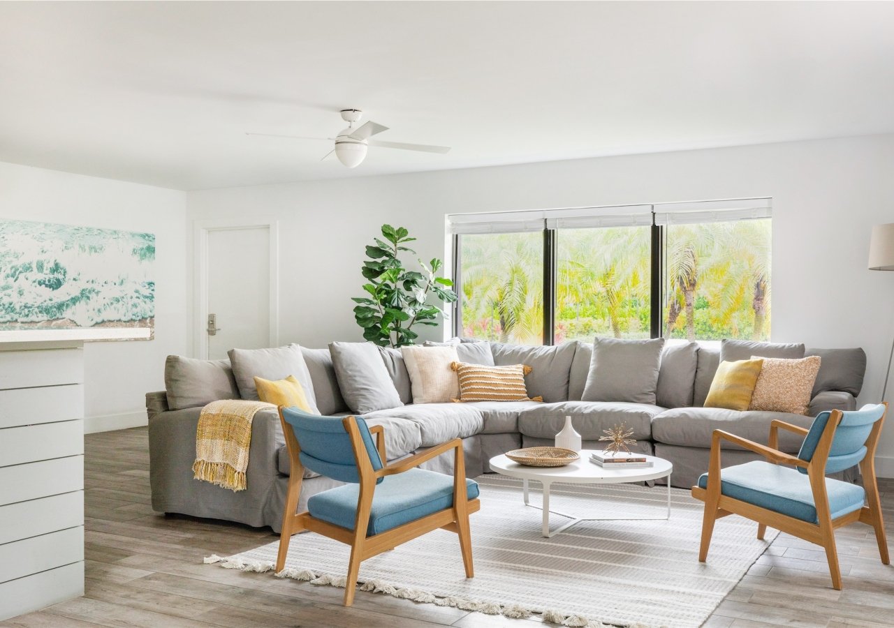 living room with large sectional and two blue chairs