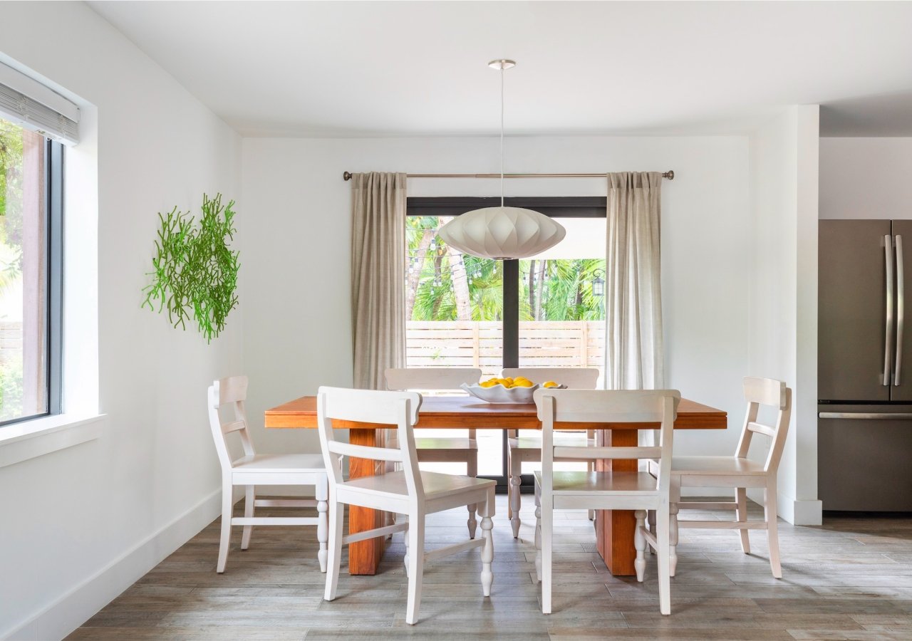 dining room with wooden table and white chairs