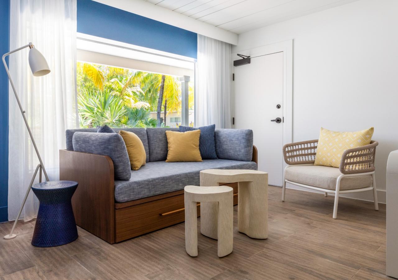 The living room area at The Village, 2 BDR Holiday Isle Suite, 1 King and 2 Queens​ at Three Waters Resort & Marina in Islamorada, Florida.
