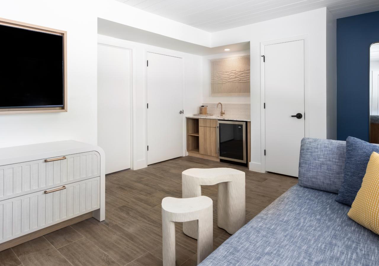 Another view of the living room area and kitchenette at The Village, 2 BDR Holiday Isle Suite, 1 King and 2 Queens​ at Three Waters Resort & Marina in Islamorada, Florida.