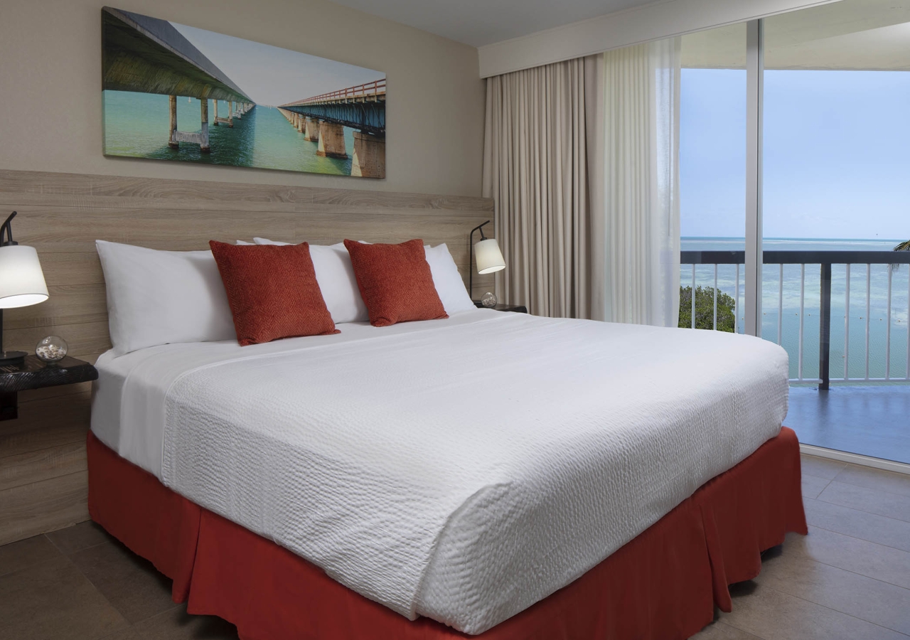 bedroom with king bedd and view of ocean