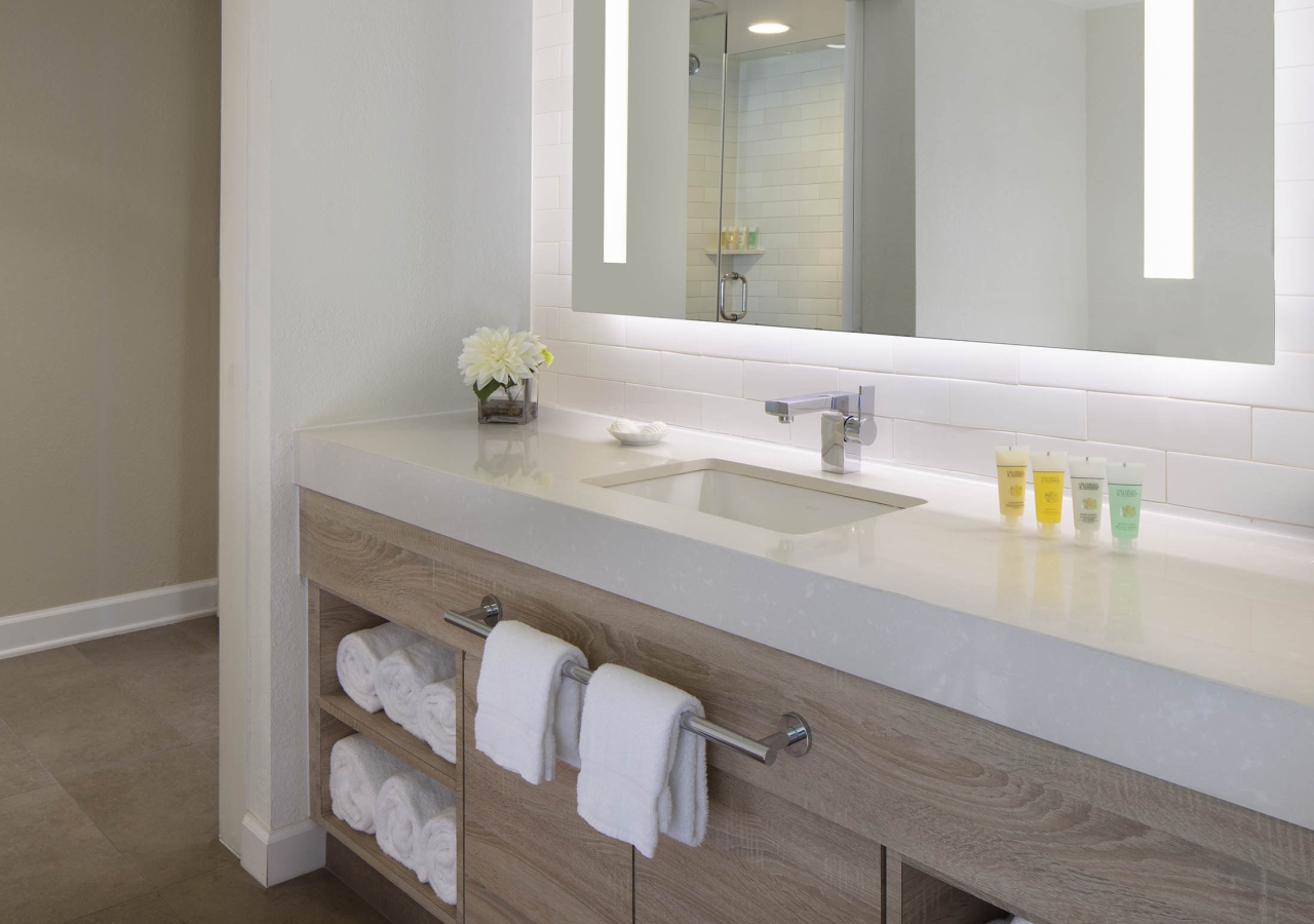 bathroom with lit up mirror
