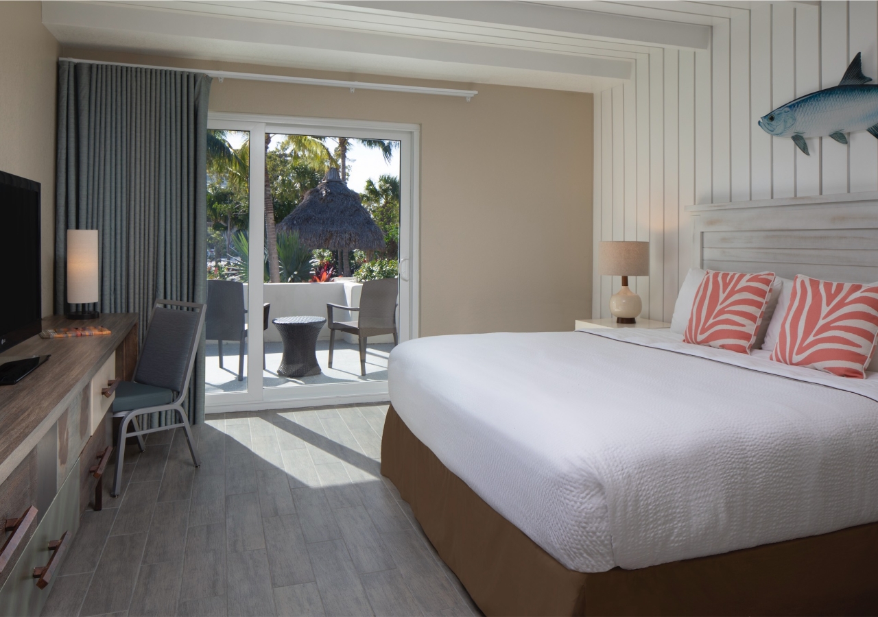 bedroom with small desk and balcony