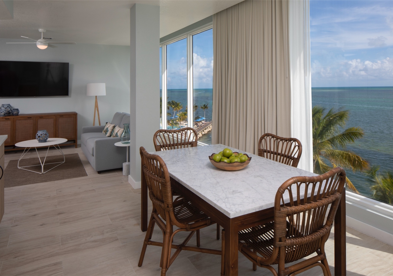 dining room with kitchen table and large picture windows with view of ocean