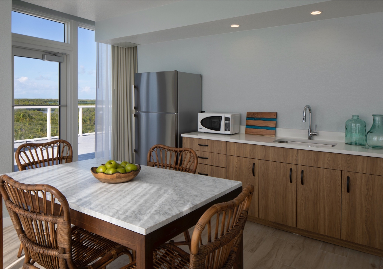 dining room and kitchen with full size fridge and microwave