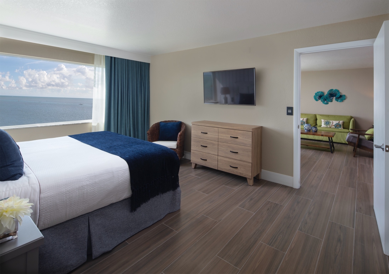 Bedroom with a large window with an ocean view