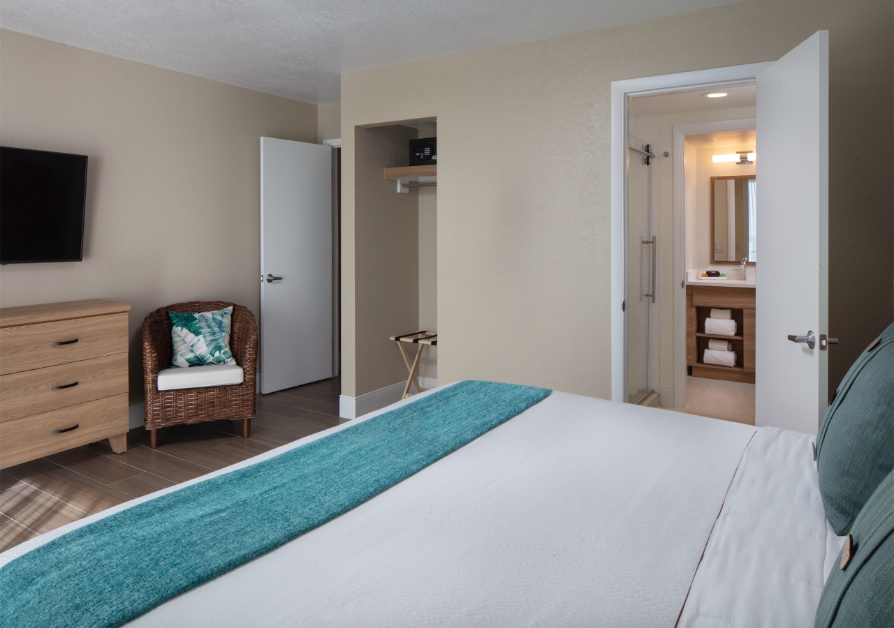 close up of a king bed with a view of the bathroom