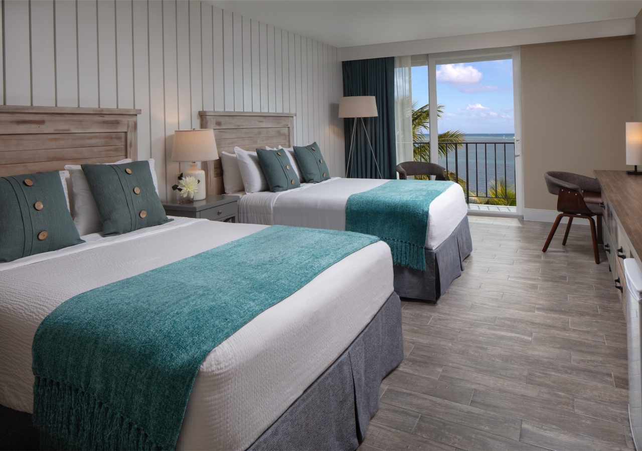 bedroom with two queen beds and small desk