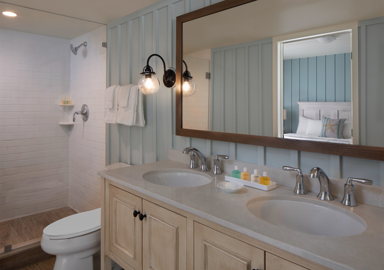 bathroom with twin sinks and walk-in shower