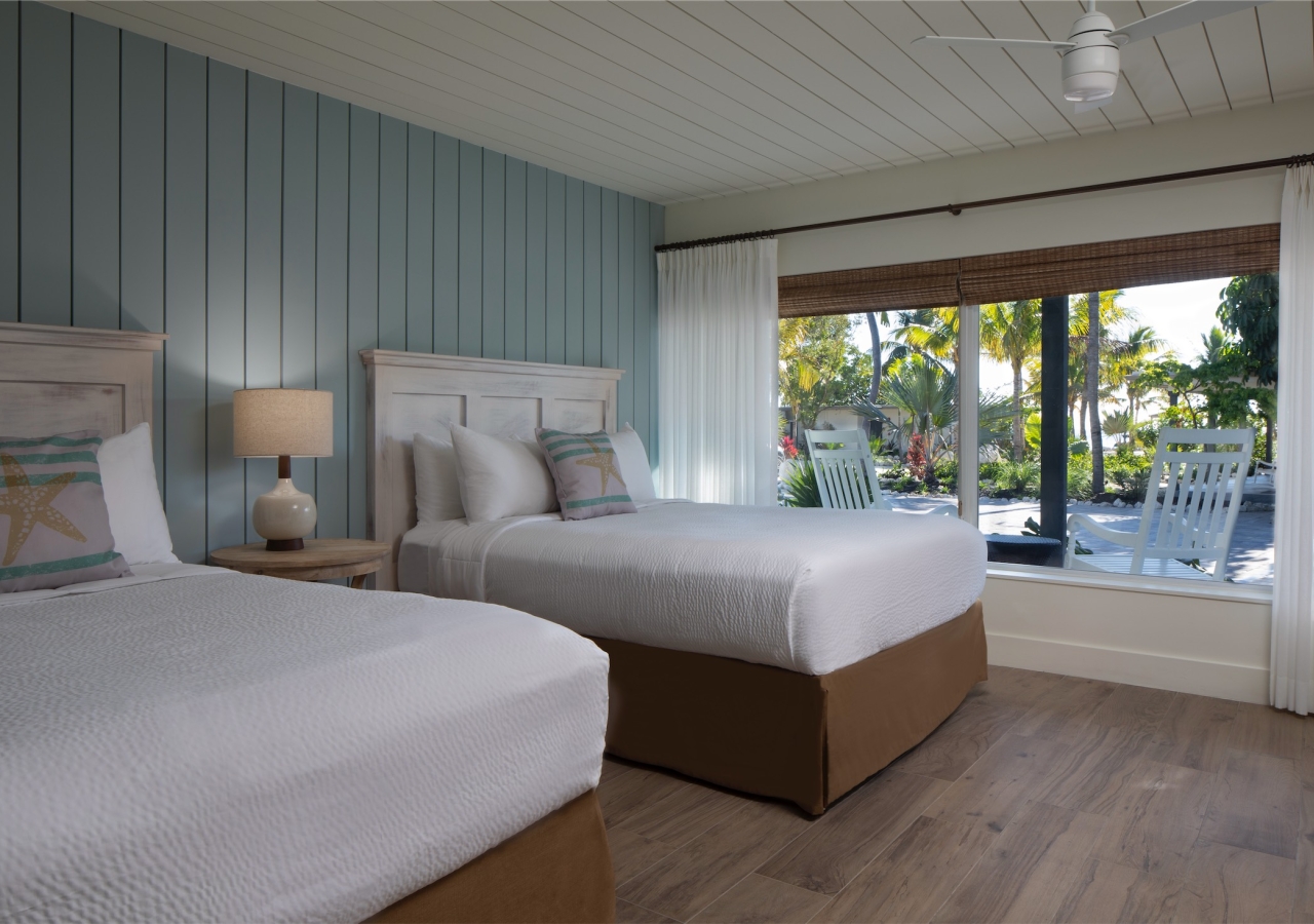 bedroom with large window and light blue wood panel accent wall