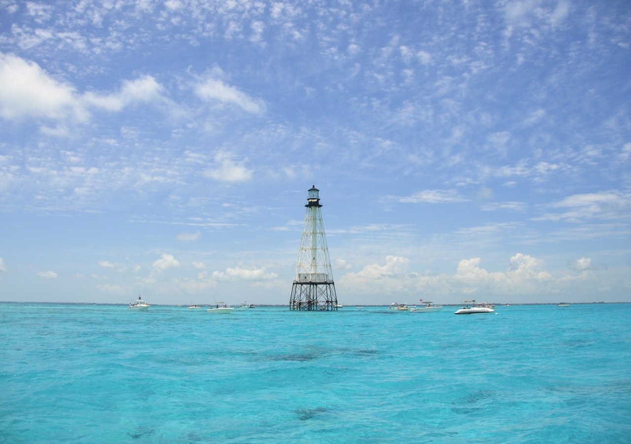 boats around a wire lighthouse